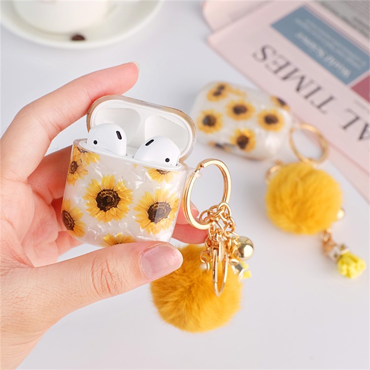 For Apple AirPods with Charging Case (2016)  /  (2019)  /  AirPods with Wireless Charging Case (2019) Shockproof TPU Cover Shell Texture Sunflower Pattern Headset Case with Hair-Ball Pendant